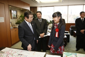 写真:奥田国土交通副大臣に作品の説明をする山本さん